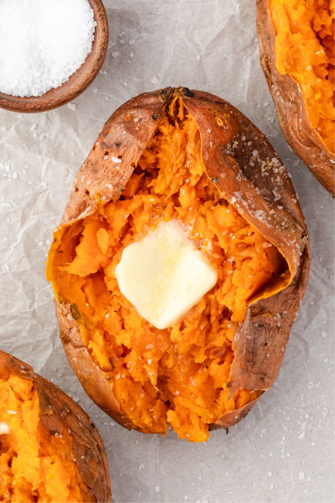 Baked sweet potato sliced open with pat of butter