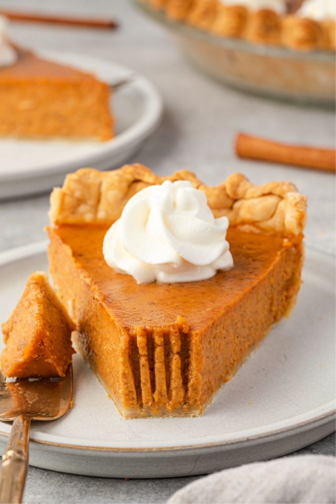 Slice of pumpkin pie from scratch with a bite take out