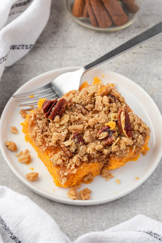 Serving of sweet potato casserole with streusel topping on a plate
