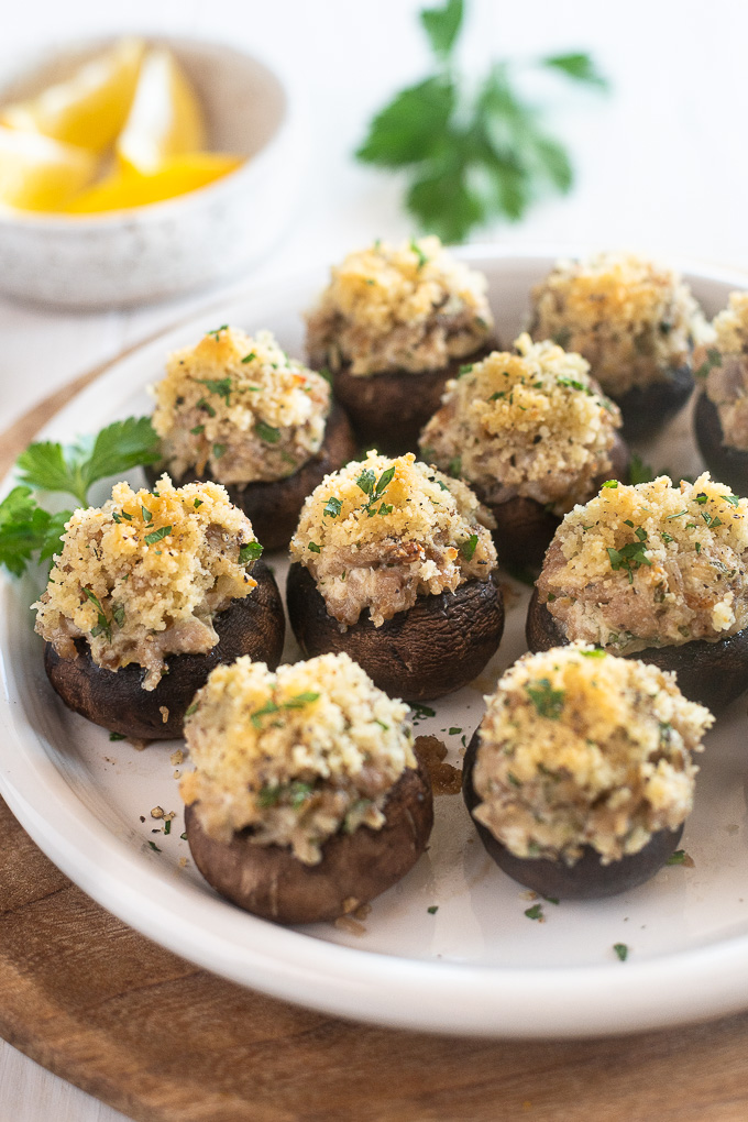 Sausage and cream cheese stuffed mushrooms on a serving plate