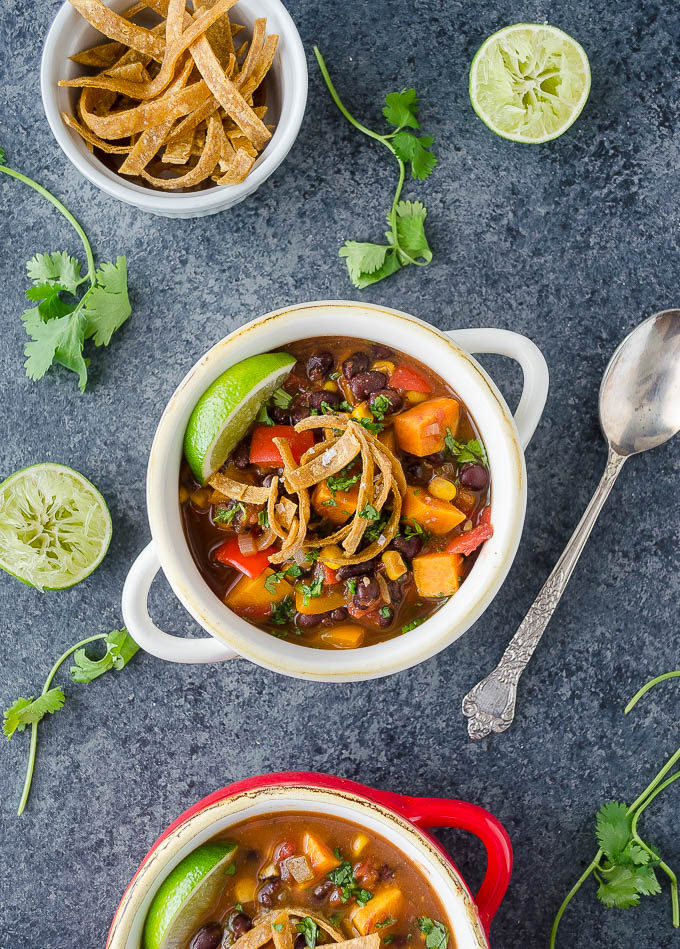 Vegan tortilla soup in a bowl with lime and cilantro