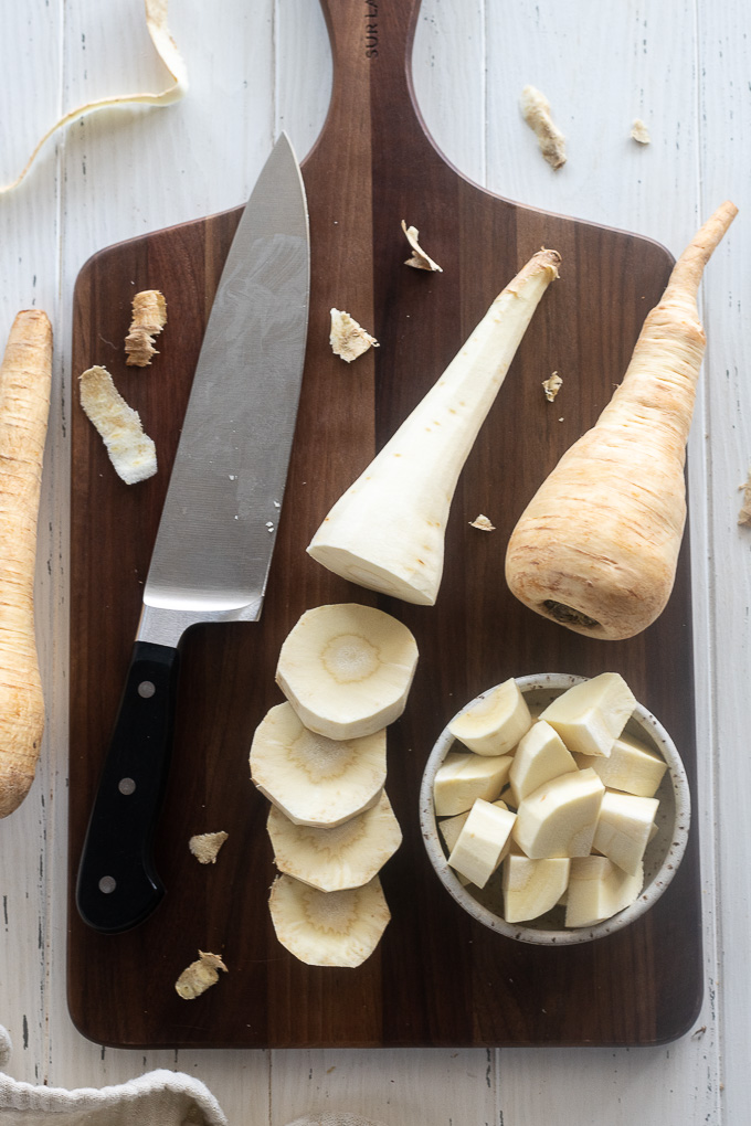 Sliced and chopped parsnips on a cutting board