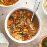Cabbage soup in a bowl with a spoon