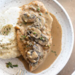 Creamy chicken marsala on a plate with mashed potatoes