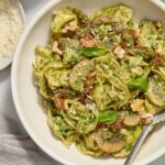 Pesto tortellini in a bowl with a fork digging in.