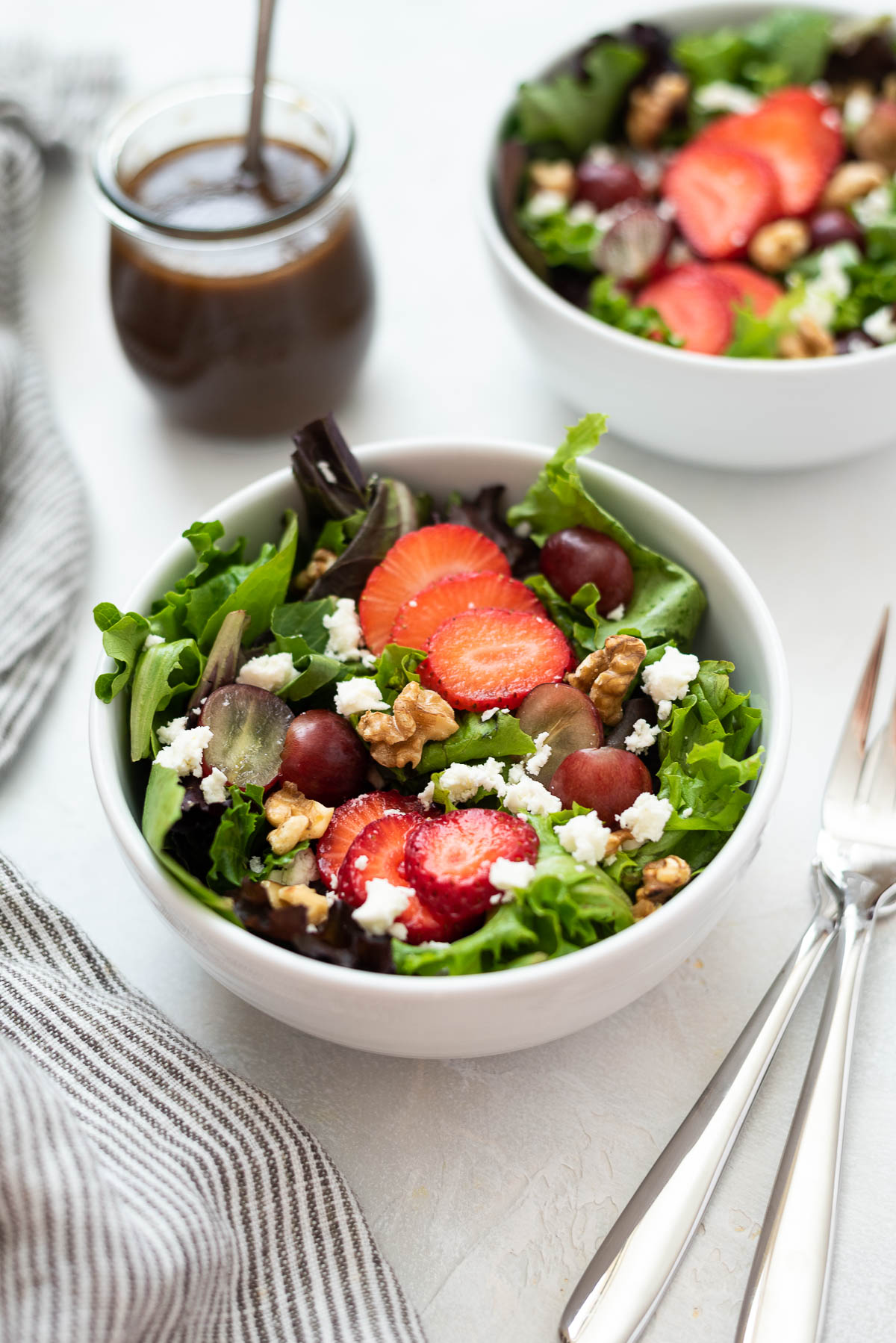 Strawberry feta salad in a white bowl.