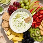 Key lime pie Greek yogurt dip in a bowl with graham cracker dipped in.