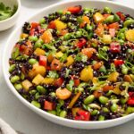Asian rice salad in a white serving bowl.
