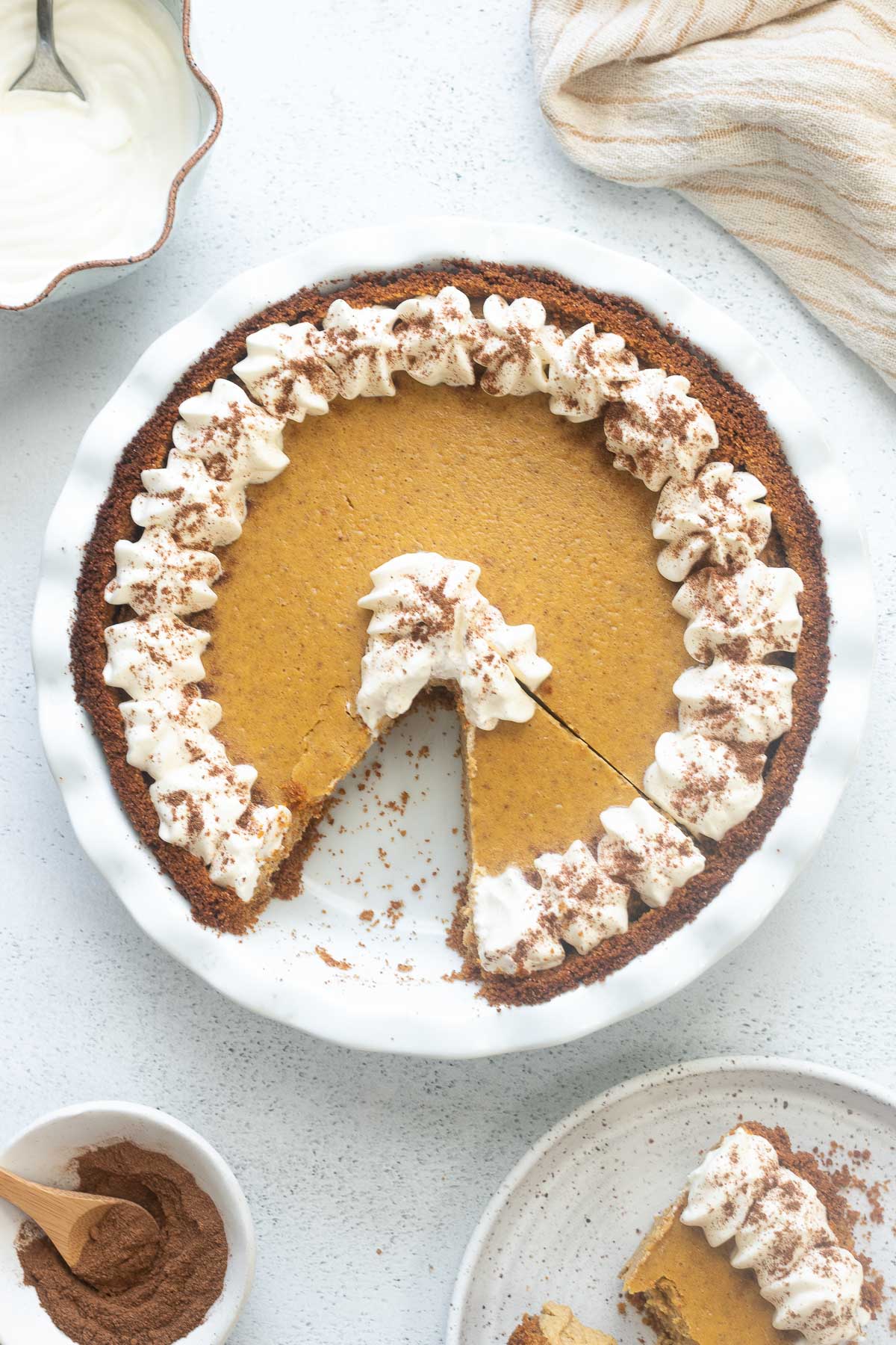 Pumpkin cheesecake pie with a slice cut out.
