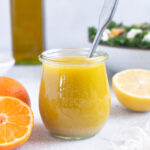 Citrus vinaigrette in a jar with spoon inside.