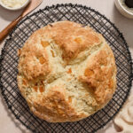 Irish soda bread with orange zest and apricots on a wire rack.