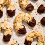 Almond horn cookies on parchment paper.