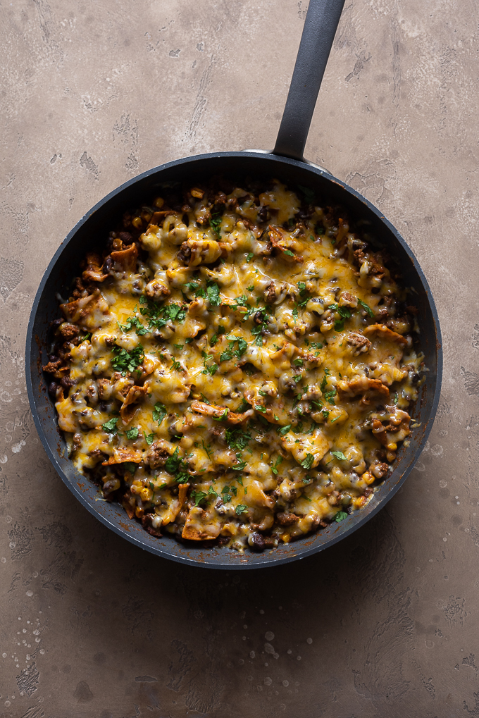 Enchilada casserole garnished with cheese and cilantro.