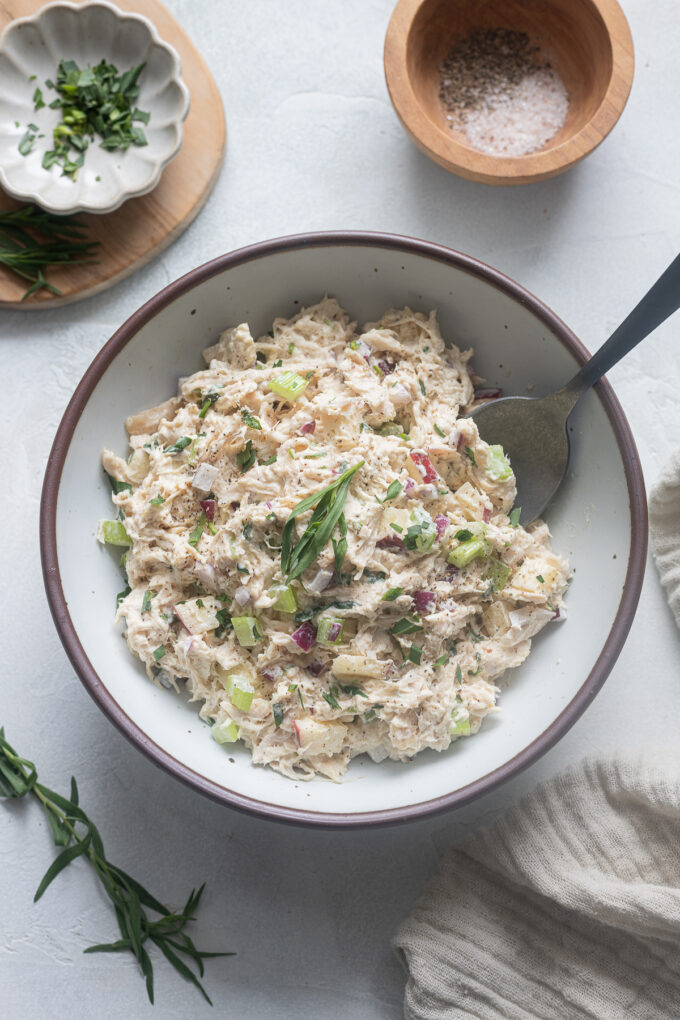 Chicken salad with tarragon and apples in a bowl.