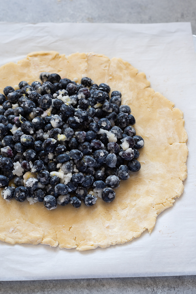 Blueberry filling in center of galette dough.
