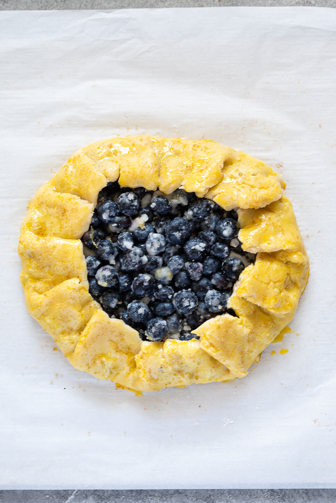 Blueberry galette before baking with egg wash.