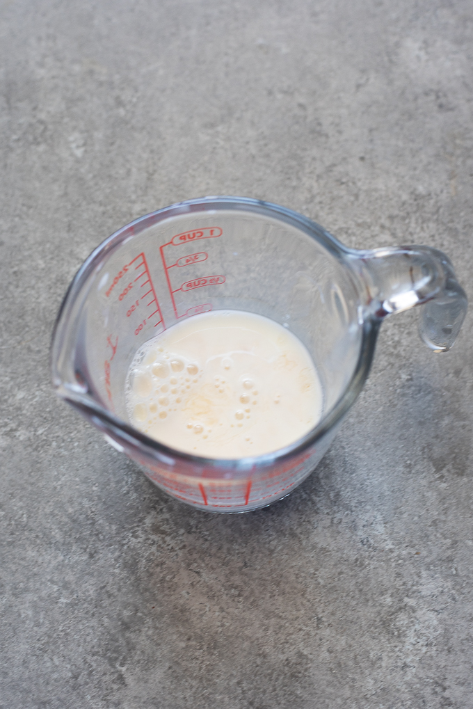 Milk and vinegar combined in a measuring cup for galette dough.