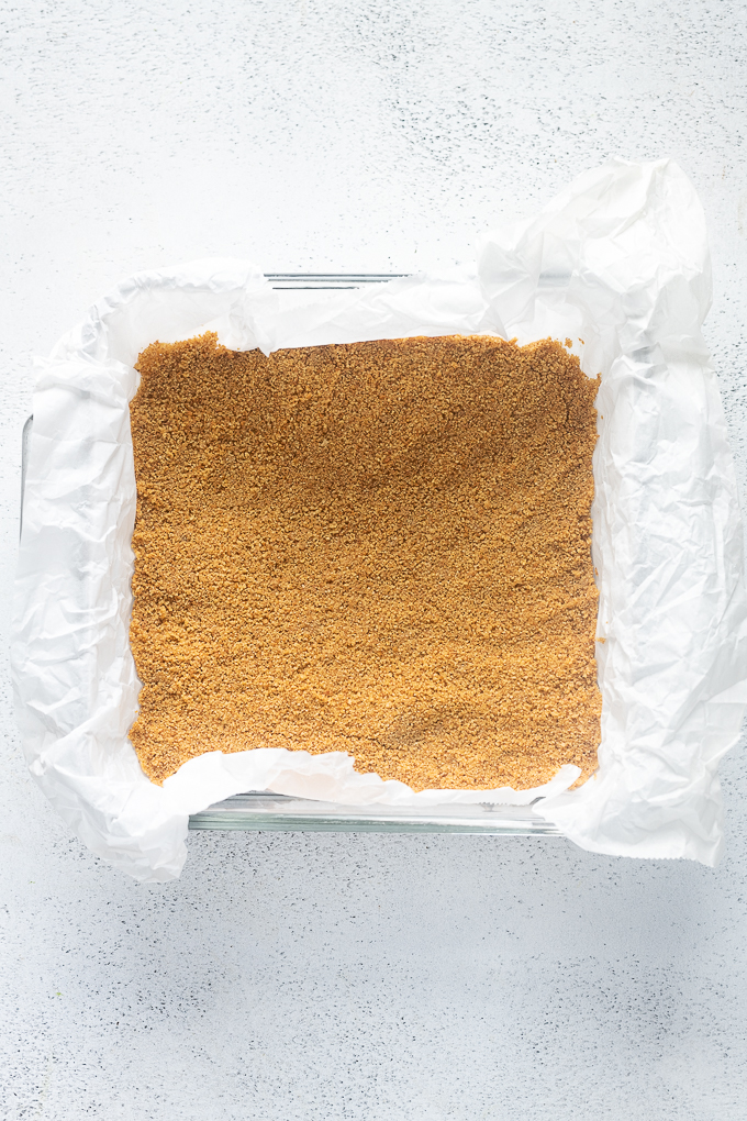 Baked graham cracker crust in 8x8" baking dish.