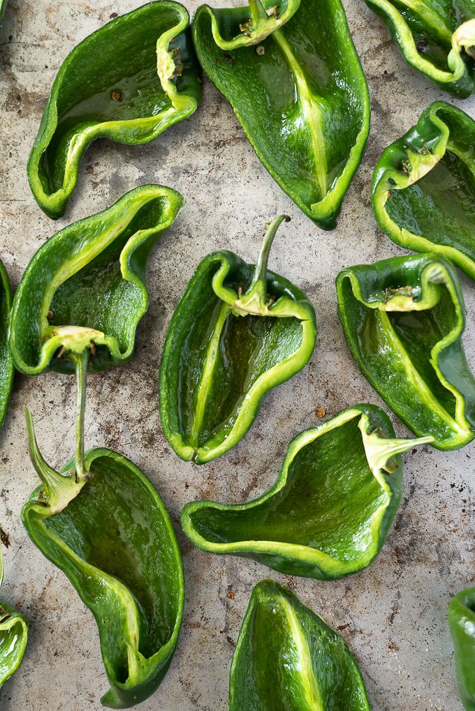 Halved poblano peppers with seeds and pith removed.