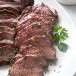 Santa Maria grilled tri tip roast sliced on a platter.