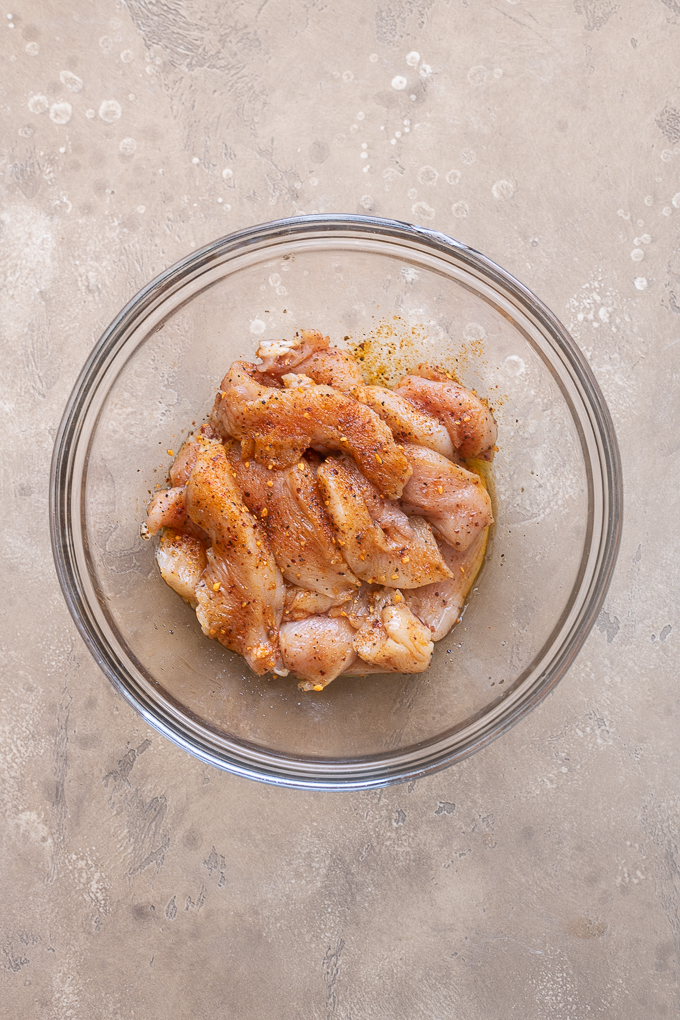 Place the sliced chicken breast in a large bowl.