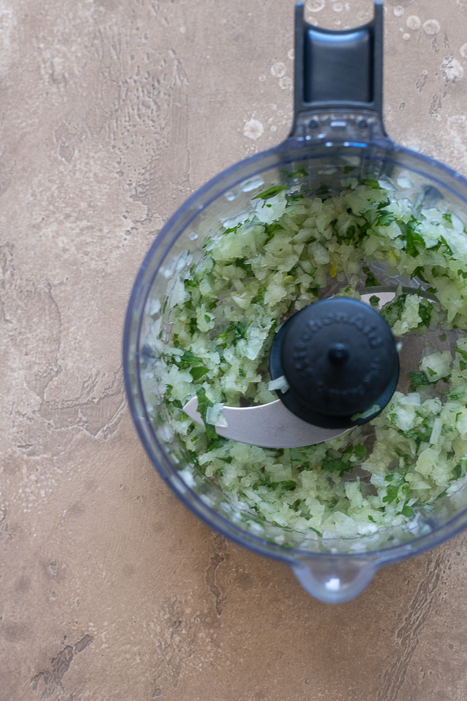 Ground cilantro, onion and garlic in food processor for lamb kofta.