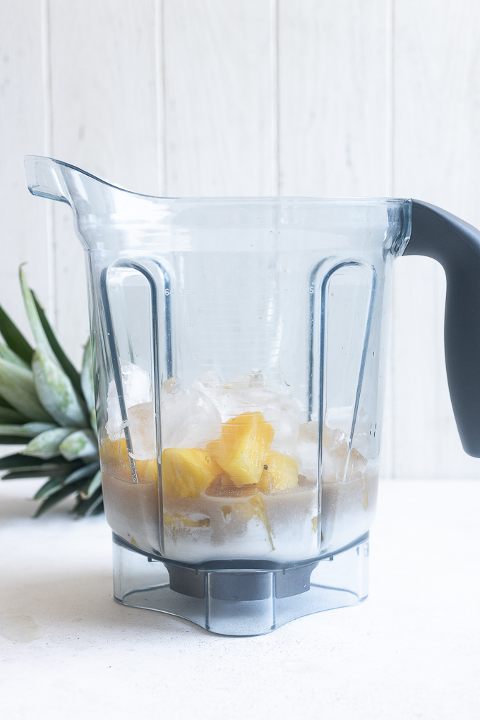 Pina colada recipe ingredients in a blender.