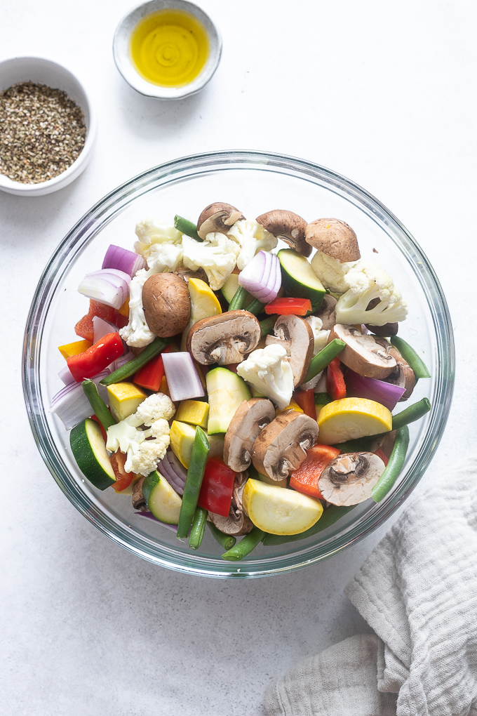 Prepped veggies for air fryer roasted vegetables in a mixing bowl.