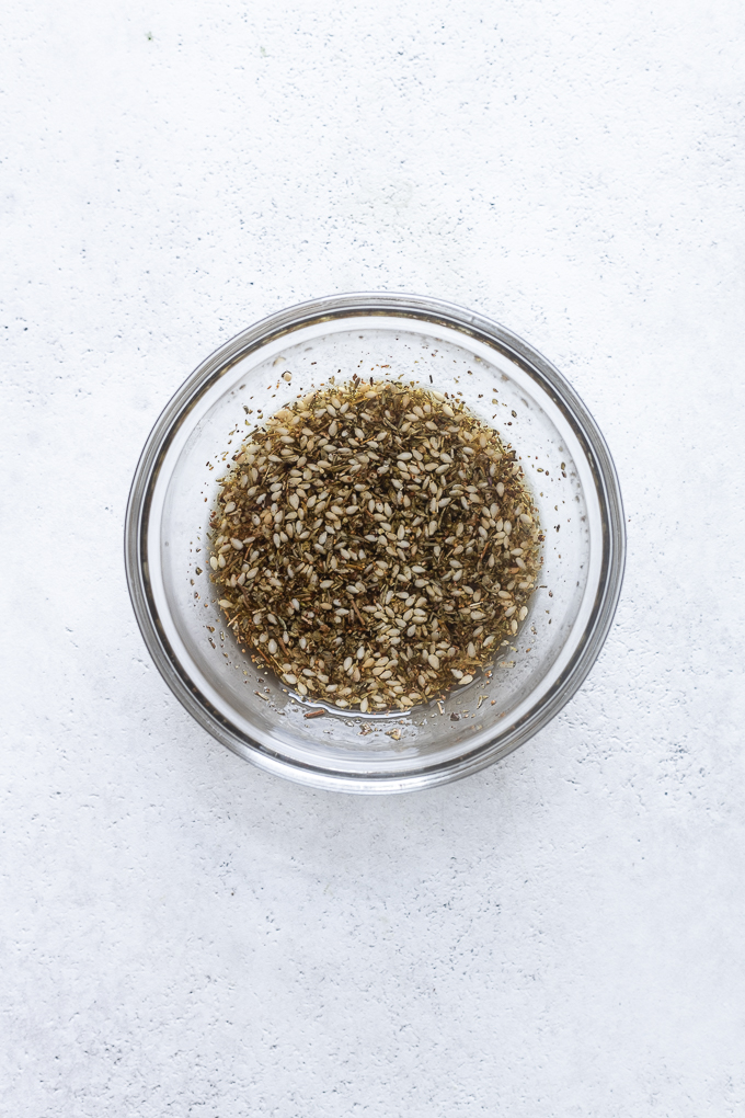 Za'atar seasoning combined with olive oil in a small bowl.