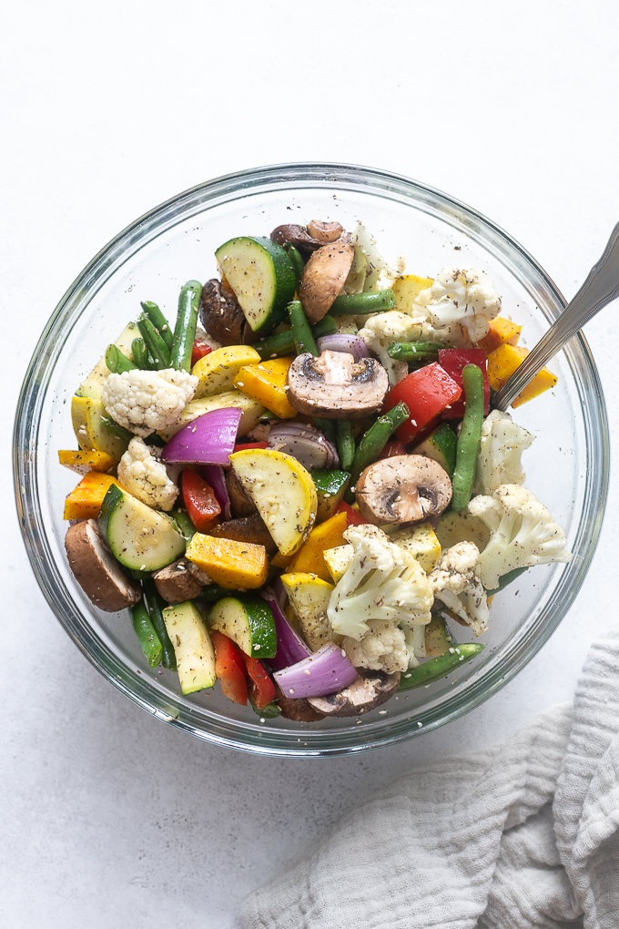 Vegetables tossed with olive oil and za'atar spice before air frying.