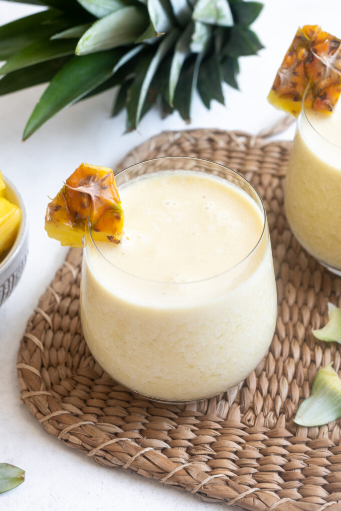 Easy pina colada in a high ball glass with pineapple garnish.
