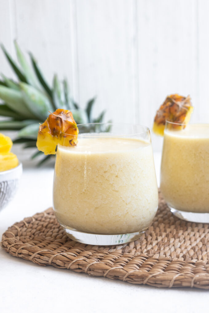 Pina colada with dark rum poured into glasses.