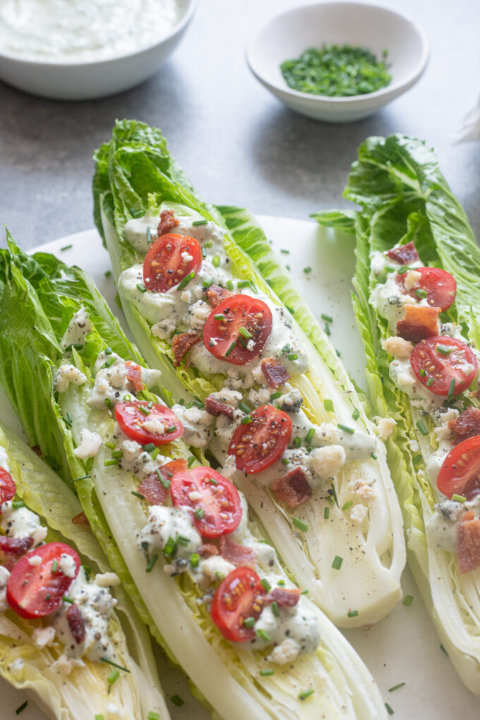 Romaine wedge salad with green goddess dressing on a platter.