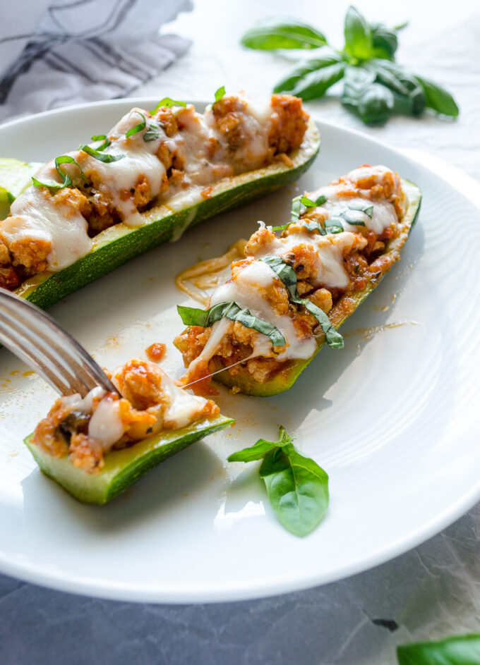 Chicken parmesan stuffed zucchini with cheese pull.