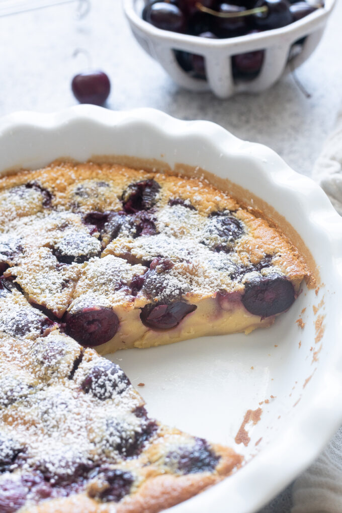 Classic French cherry clafoutis sliced in the pan.