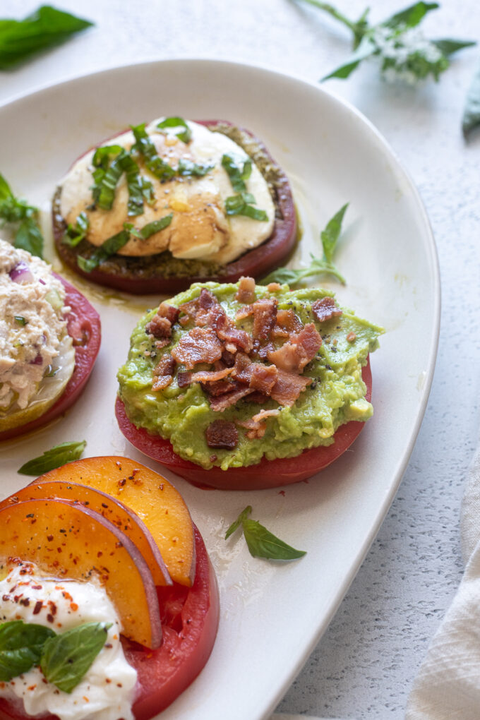 Heirloom tomato flight with avocado toast with bacon topping.