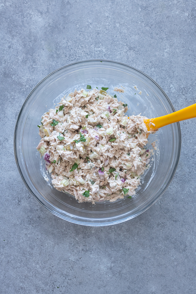 Dill pickle tuna salad combined in a mixing bowl.