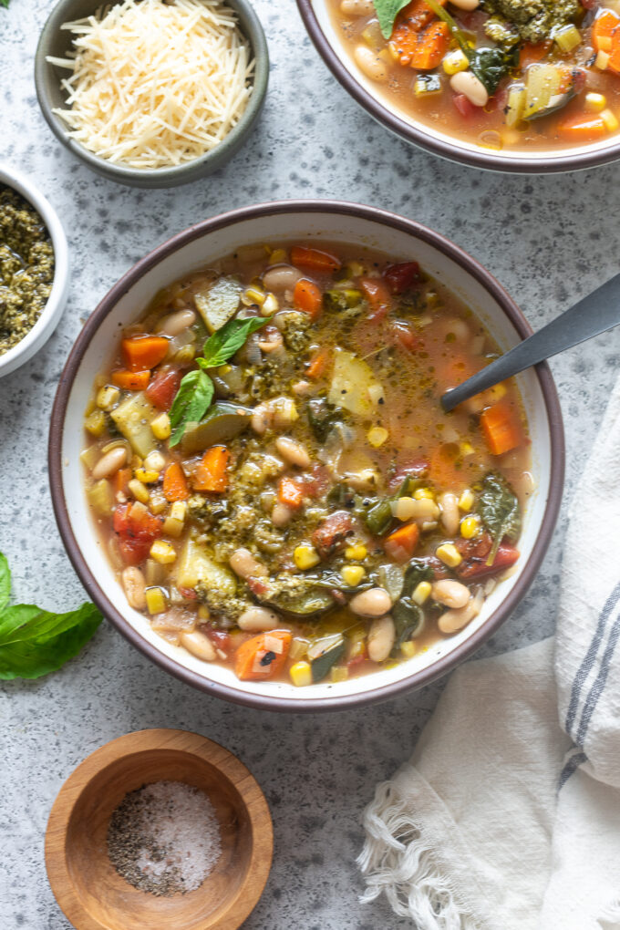 Soupe au pistou in a bowl with basil sprig.