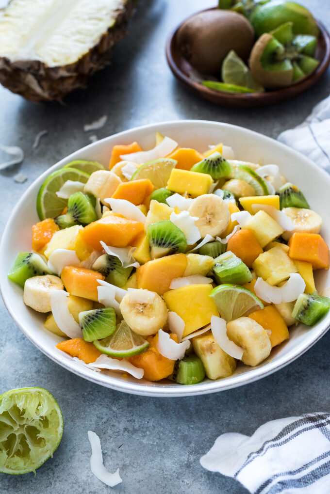 Tropical fruit salad with coconut in a serving bowl.