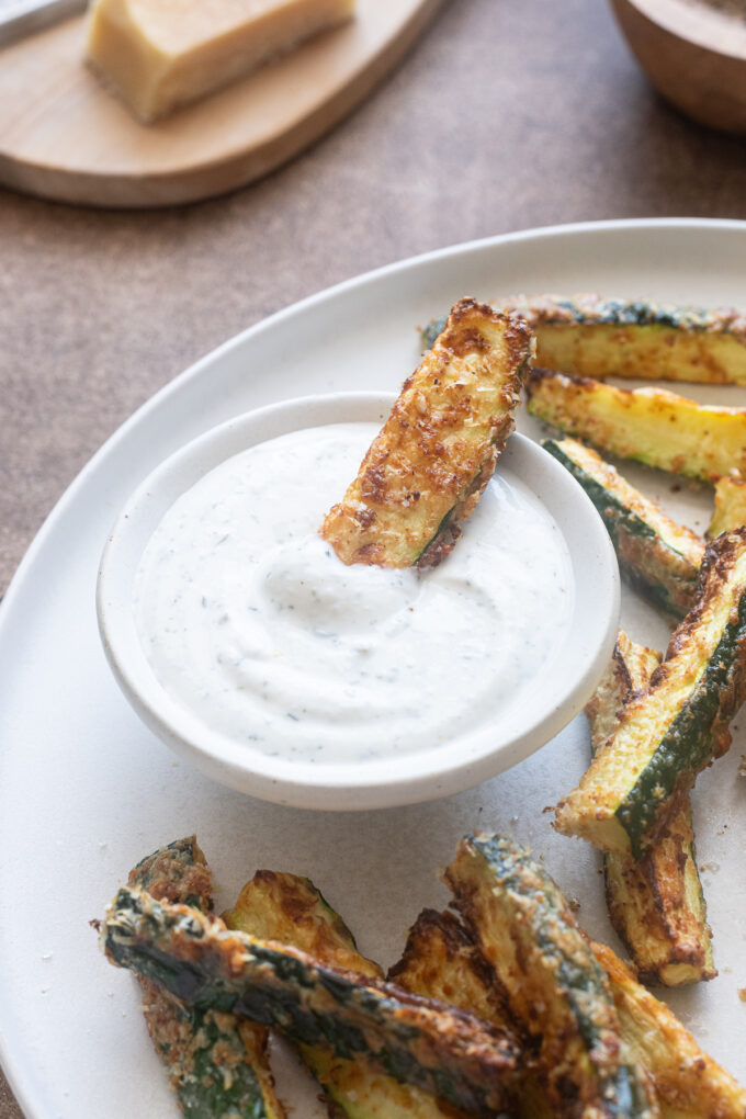 Air fryer zucchini fries with no breadcrumbs dipped in Greek yogurt ranch.
