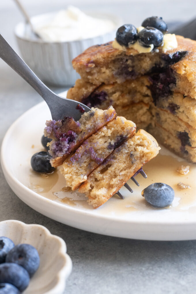 Forkful of Greek yogurt pancakes with blueberries.