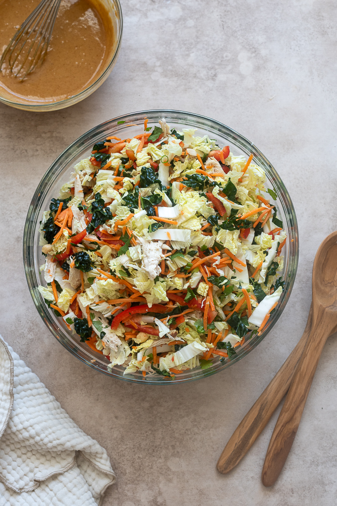 Thai peanut salad ingredients combined in mixing bowl.