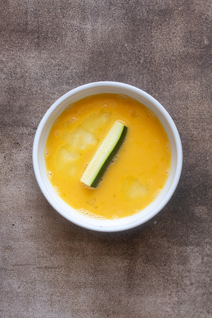 Zucchini fries dipped in egg.