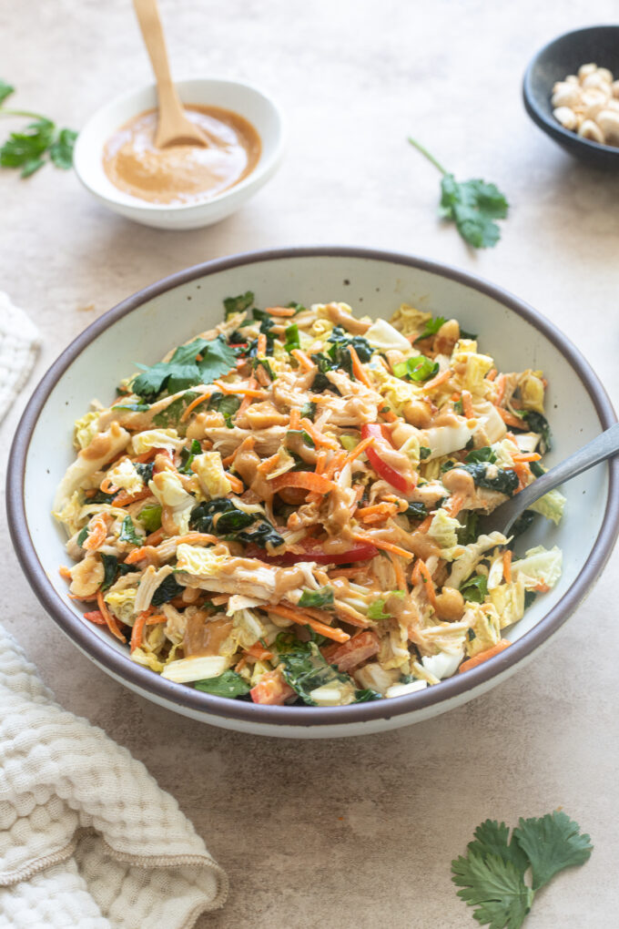 Thai chicken salad with peanut dressing in a bowl.