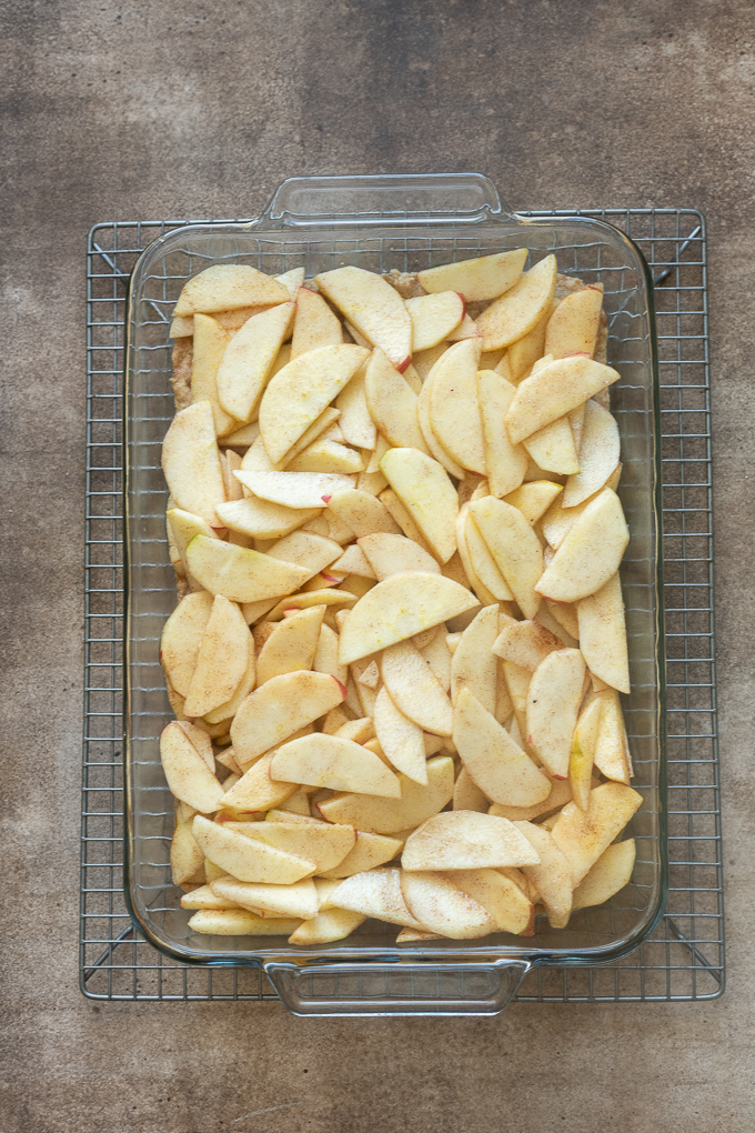 Place apple filling over baked shortbread crust for apple pie bars.