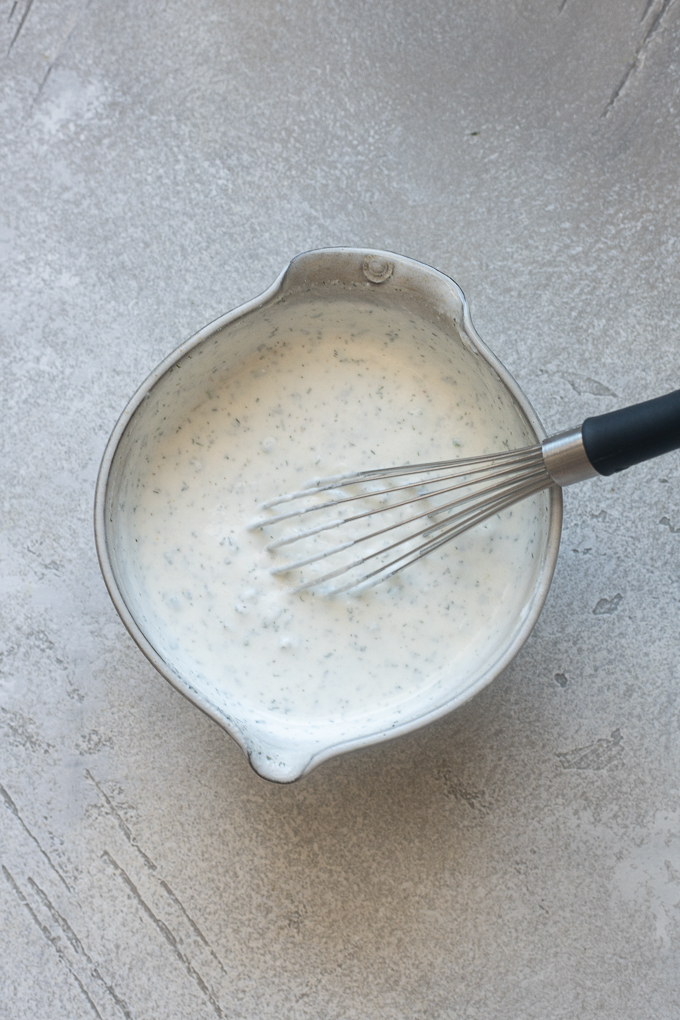 Ingredients for ranch dressing using Greek yogurt combined in a bowl.