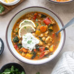 Chicken moroccan soup in a bowl with lemon and Greek yogurt.