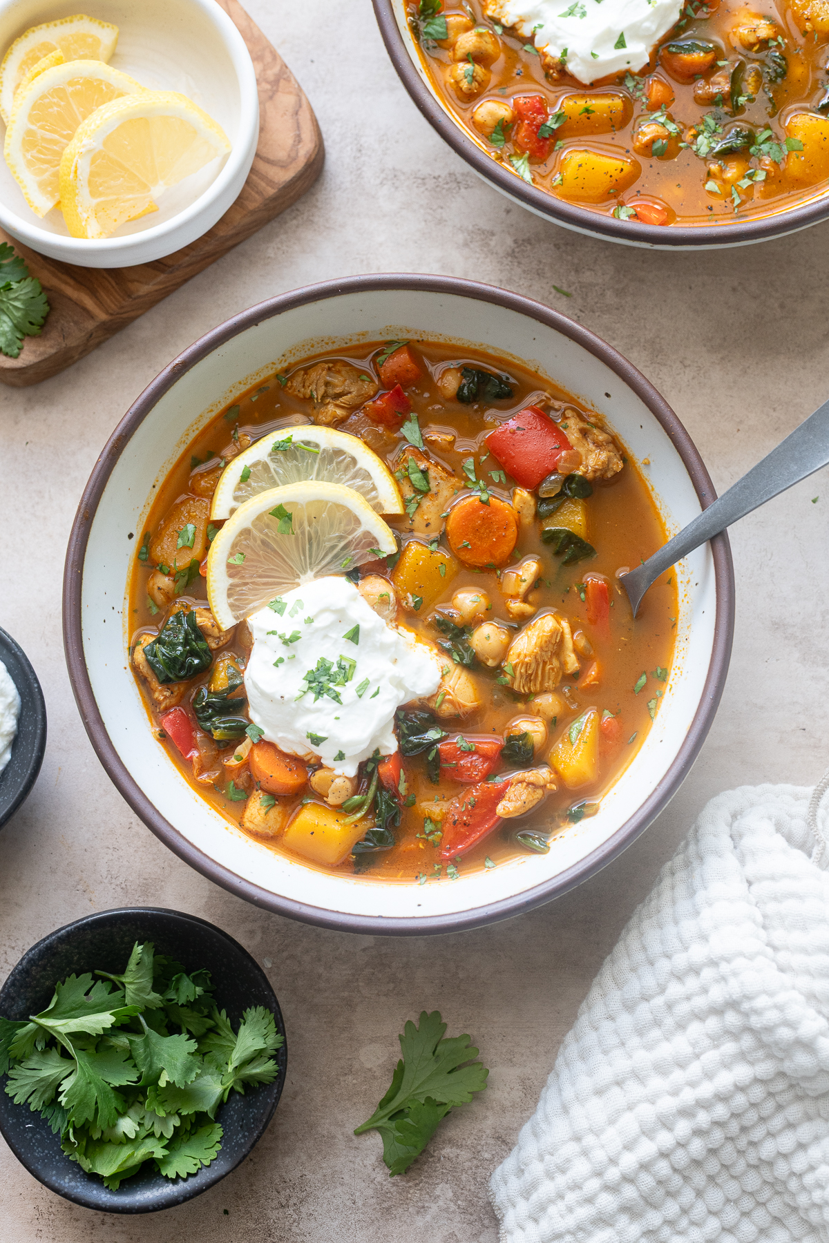 Chicken moroccan soup in a bowl with lemon and Greek yogurt.