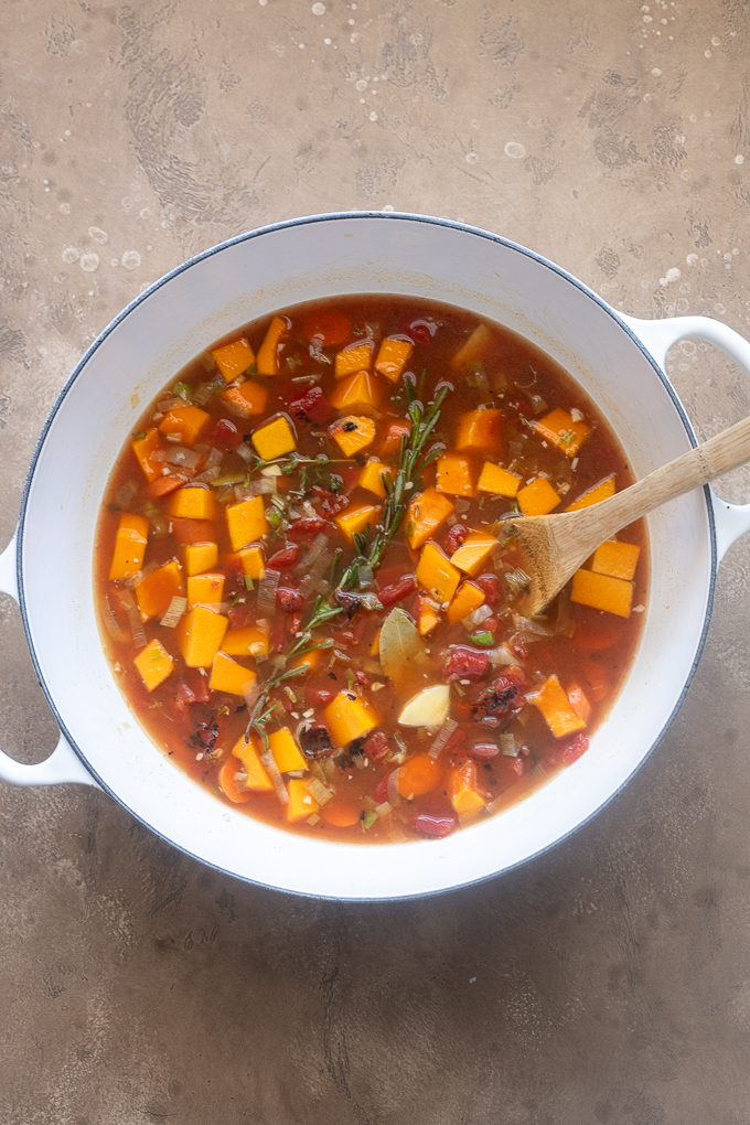 Fall vegetable soup in a Dutch oven before simmering.