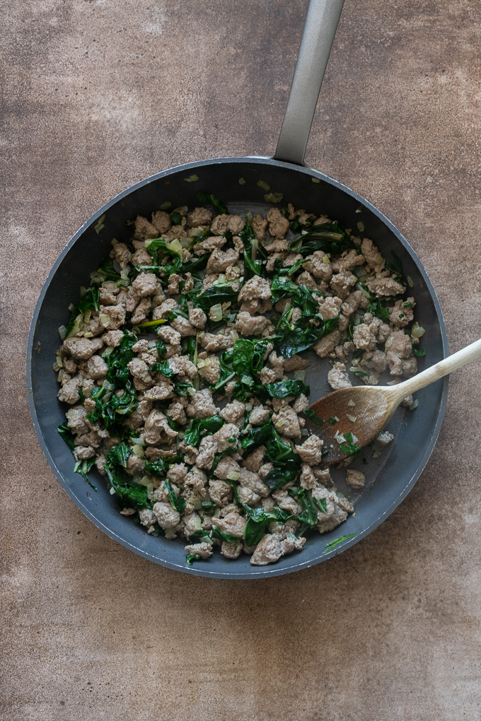 Breakfast sausage filling cooked in skillet for breakfast casserole with sausage.